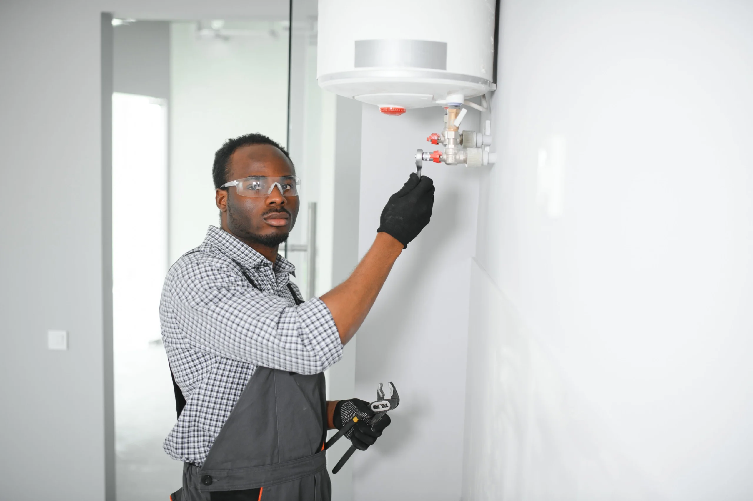 Local boiler repair technician in Philadelphia adjusting water heater settings.