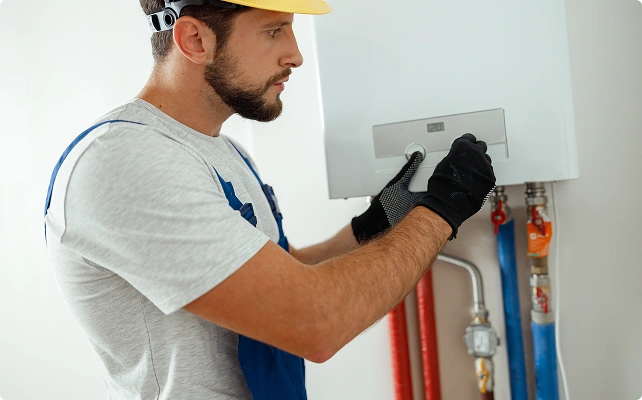 A man repairs a boiler
