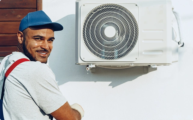 man repairs Heat Pump
