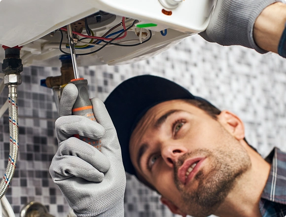A man repairs a boiler
