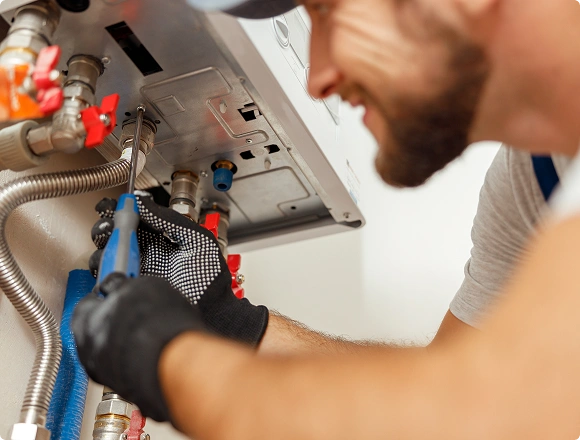 A man repairs a boiler