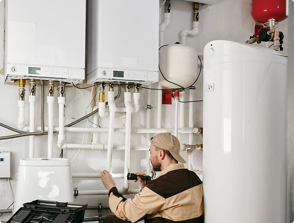 A man repairs a boiler