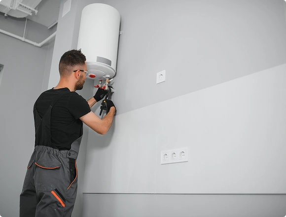 A man repairs a boiler