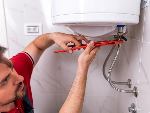 A man repairs a boiler