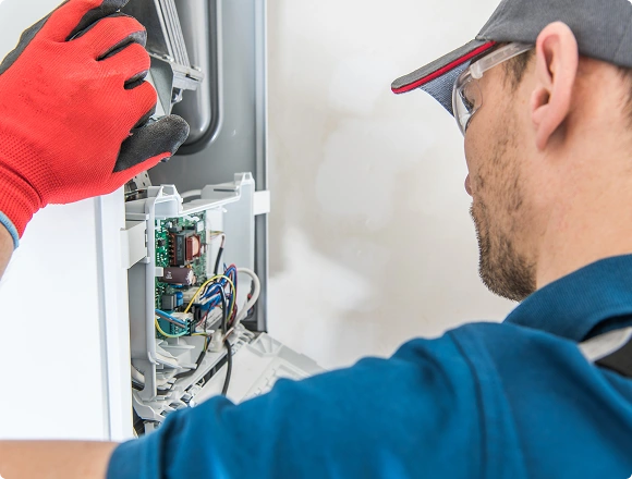 A man repairs a boiler