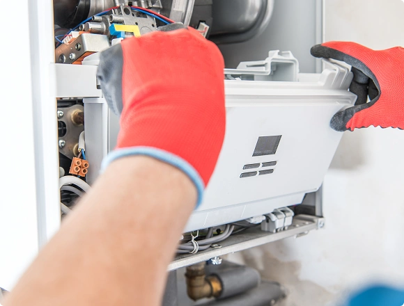 A man repairs a boiler