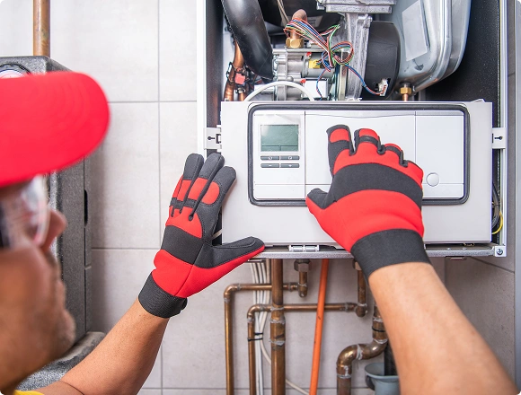A man repairs the heating system.