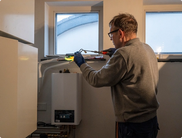 man repairs gas station