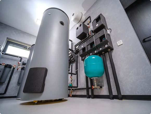 Modern residential boiler room with hot water tank, expansion vessel, and insulated piping system, wide interior view
