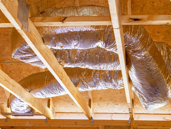 Flexible insulated HVAC air ducts installed in the ceiling of a residential building