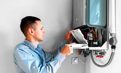 Technician inspecting internal components of a wall-mounted water heater.