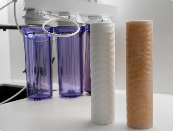 New and used water filter cartridges placed in front of a reverse osmosis filtration system
