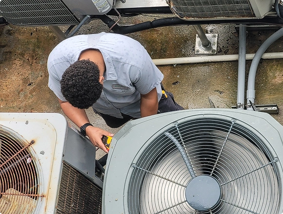 Claude responded: HVAC technician servicing rooftop air conditioning units from aboveHVAC technician servicing rooftop air conditioning units from above