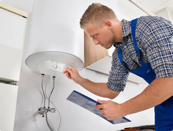 Technician inspecting an electric water heater