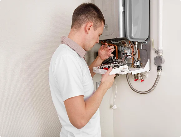 Heating technician repairing a gas boiler